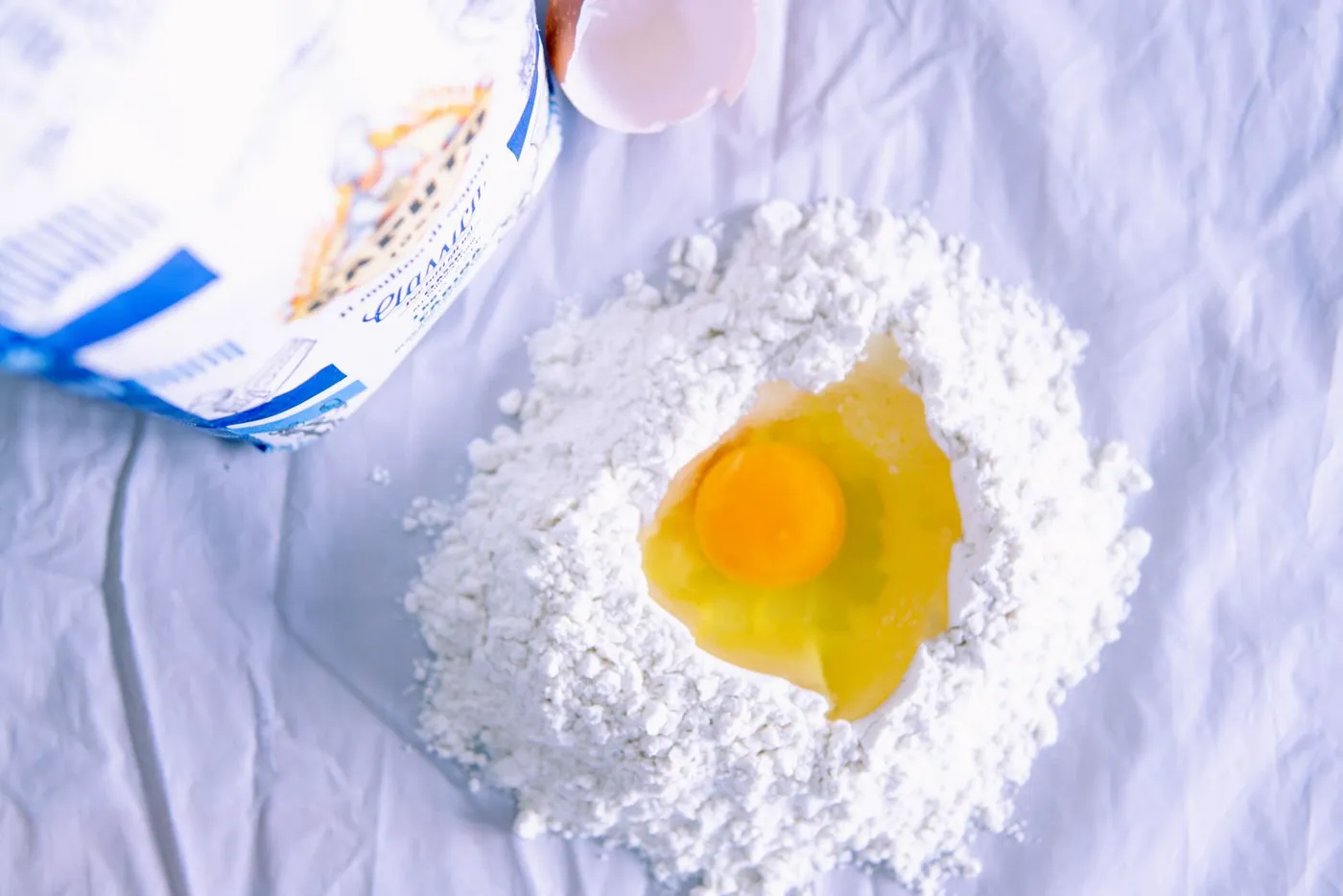 Egg in a well of flour for pasta dough