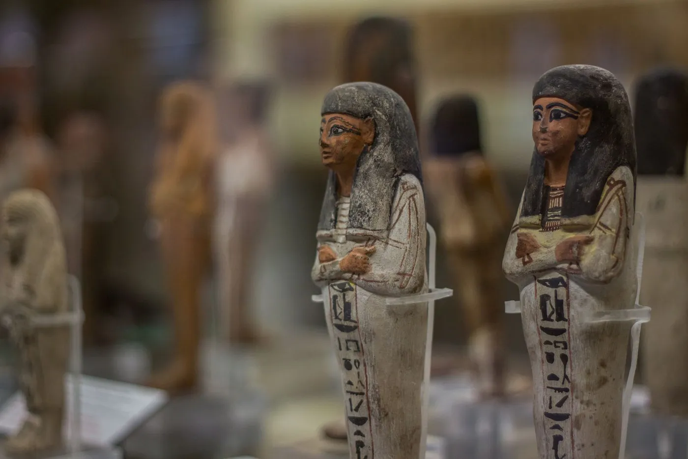 Small funerary figurines (shabtis) in a display case at the Egyptian Museum in Turin