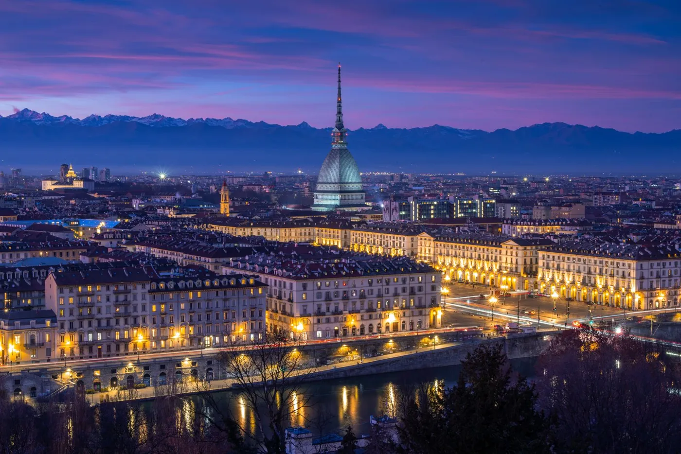 Turin at night with the Mole Antonelliana and the Alps