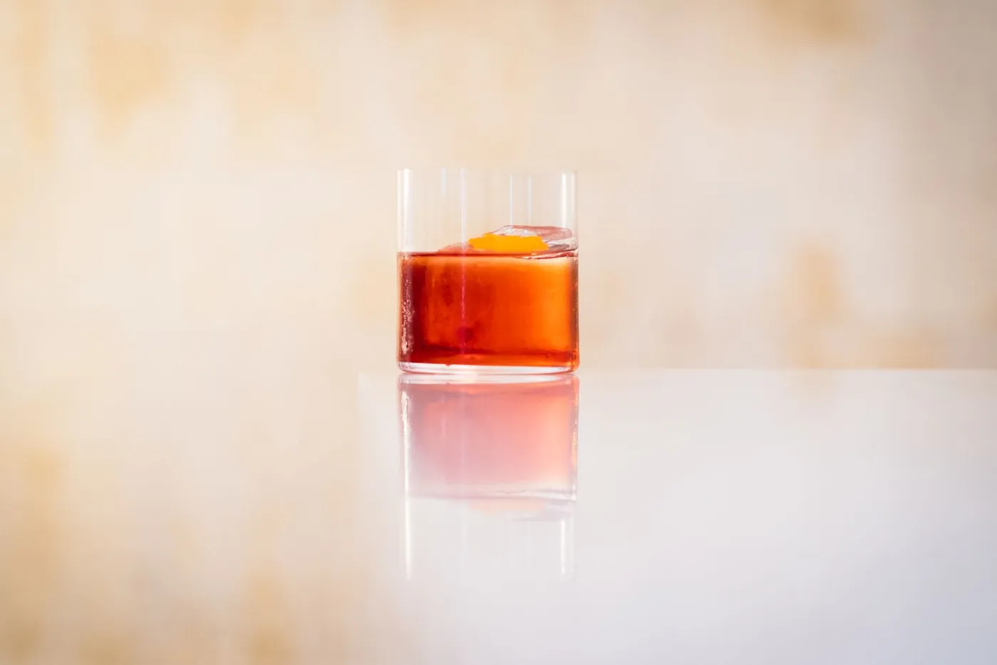 Glass of red aperitif with an orange twist