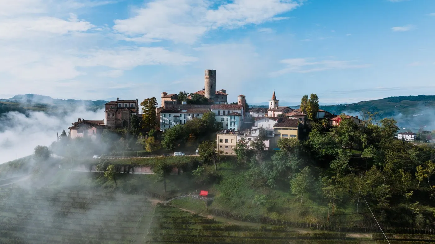 Castiglione Falletto in the Langhe in morning mist above the vineyards